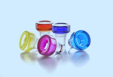 Production of transparent and colored glass caps for sealing glass bottles